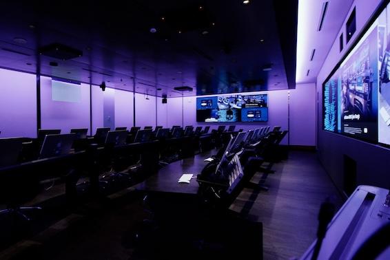 Photo of a classroom with rows of computers and empty 