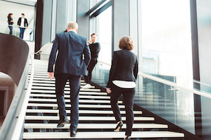 Two people going up the stairs 