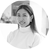 Woman of asian descent with long hair wearing a light colored turtleneck