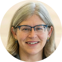 Older woman with grey hair and wearing glasses