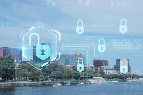 Photo of a city skyline with cyber security shield graphics overlayed