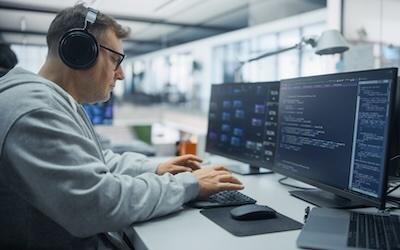 Older man working on code on a desktop