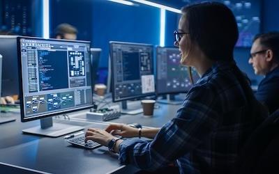 Business woman working on code with a desktop