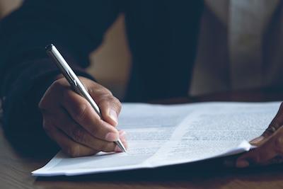 Image of a business person reviewing a policy document