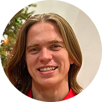 Business with long hair wearing a red collared shirt